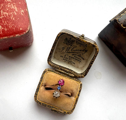 Early 20th century gold diamond, ruby and sapphire three-stone ring