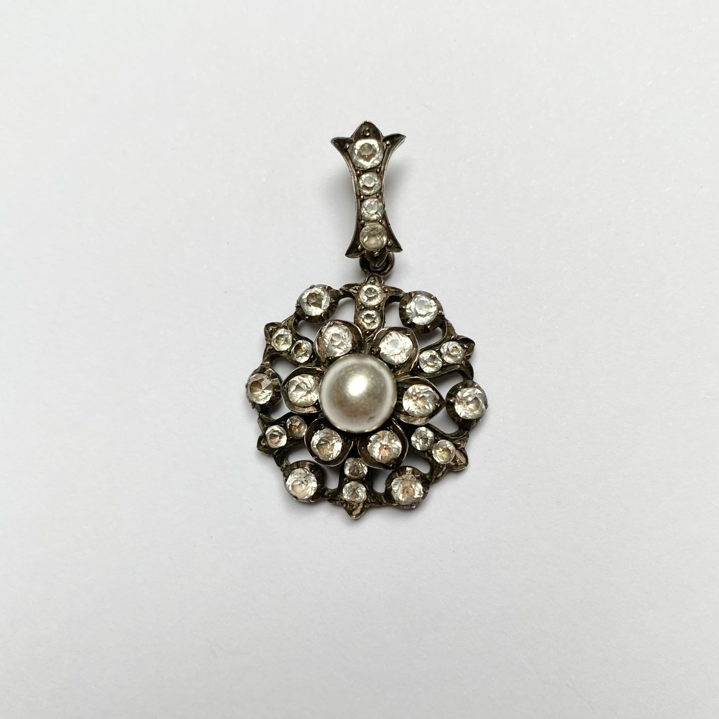 Antique early 20th century silver, colourless paste and imitation pearl cluster pendant.