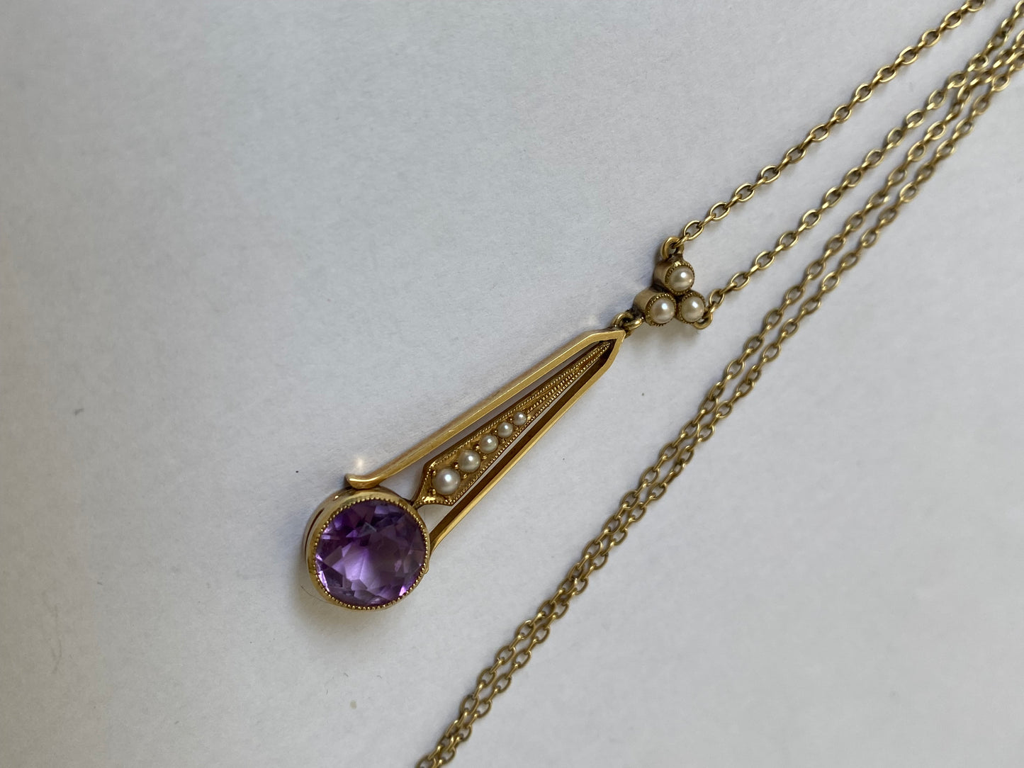 An Edwaridan 15ct gold amethyst and split pearl pendant, with integral chain.