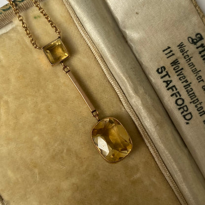 An Edwardian 9ct gold citrine pendant, with integral chain.