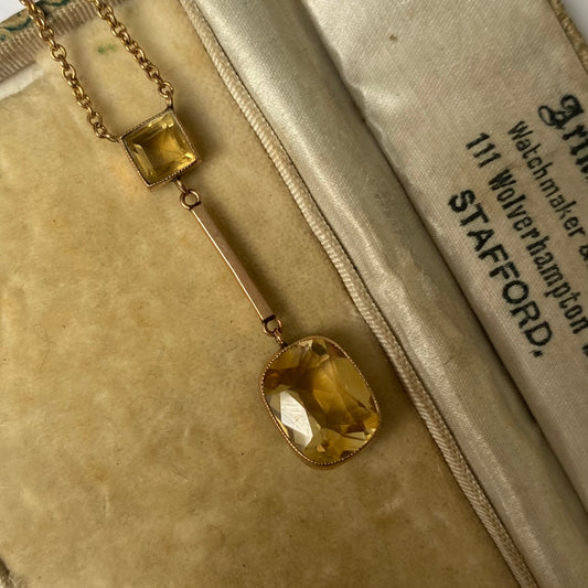 An Edwardian 9ct gold citrine pendant, with integral chain.