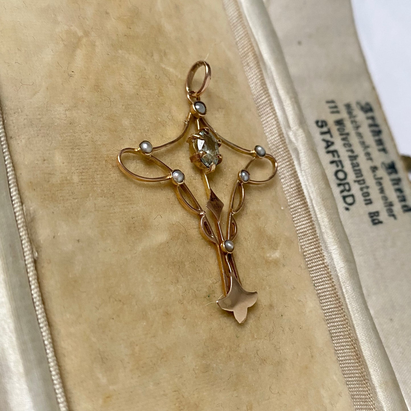 An Art Nouveau gold topaz and split pearl pendant.