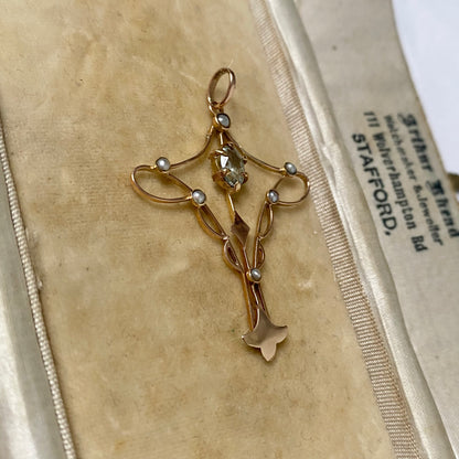 An Art Nouveau gold topaz and split pearl pendant.