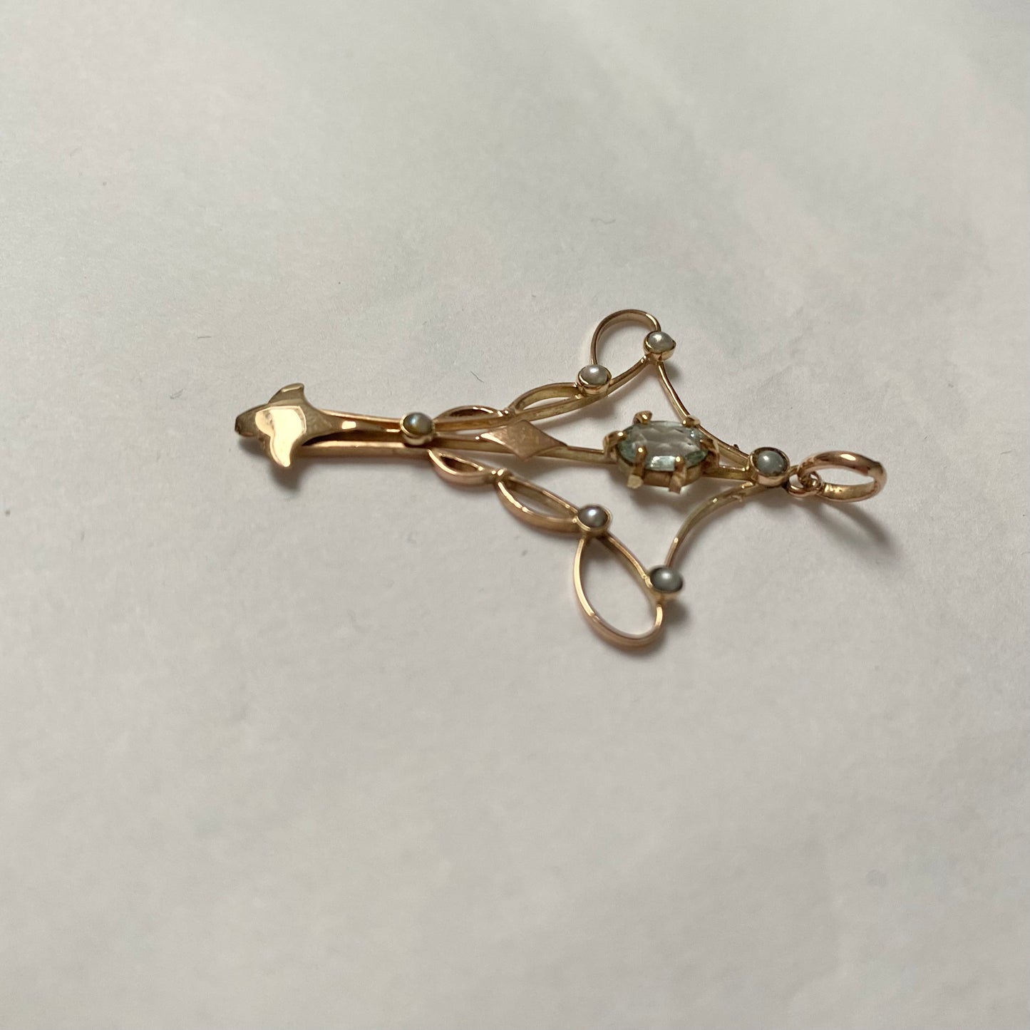 An Art Nouveau gold topaz and split pearl pendant.