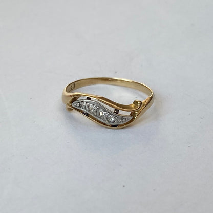 A mid 20th century gold old cut diamond undulating pinky ring.