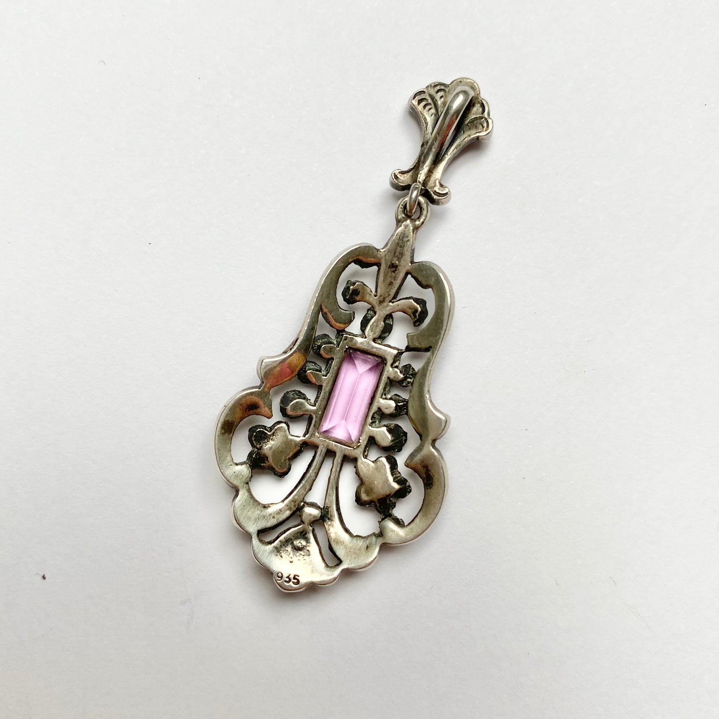 An early 20th century colourless and purple paste foliate pendant.
