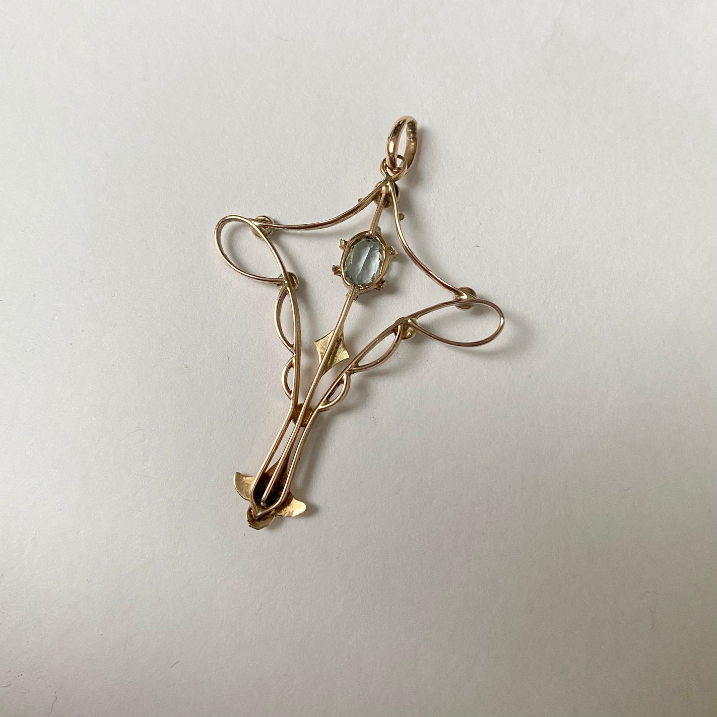 An Art Nouveau gold topaz and split pearl pendant.