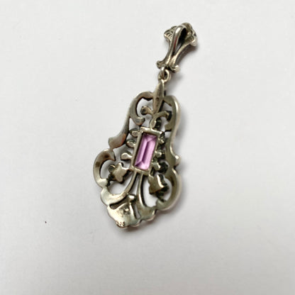 An early 20th century colourless and purple paste foliate pendant.