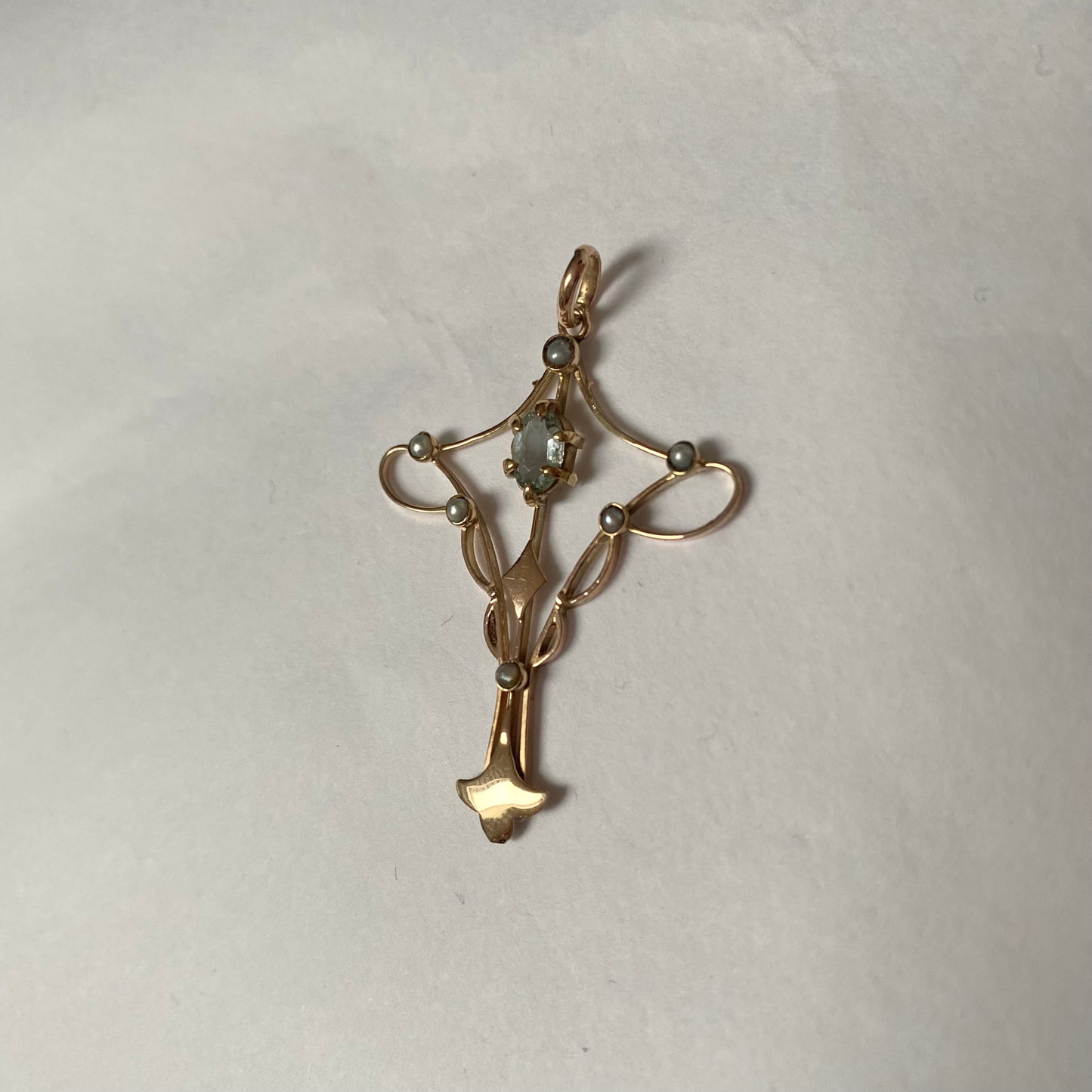 An Art Nouveau gold topaz and split pearl pendant.