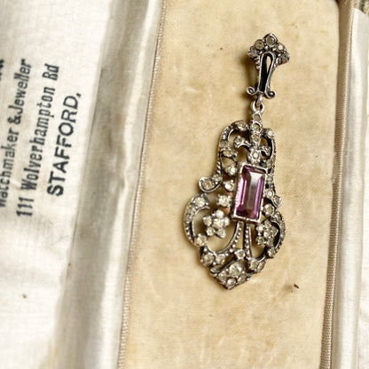 An early 20th century colourless and purple paste foliate pendant.