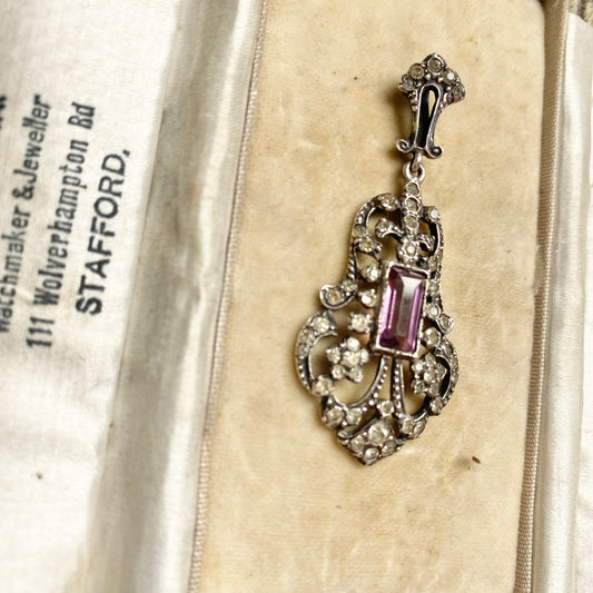 An early 20th century colourless and purple paste foliate pendant.