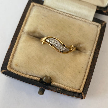 A mid 20th century gold old cut diamond undulating pinky ring.