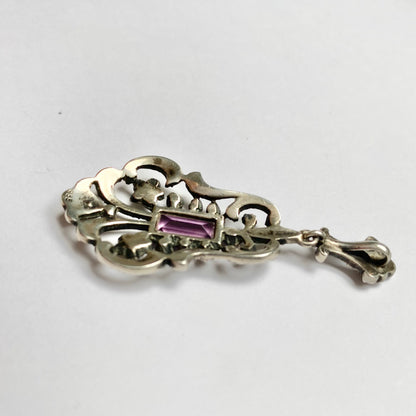 An early 20th century colourless and purple paste foliate pendant.