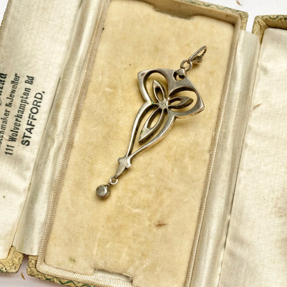 An Edwardian silver colourless paste foliate pendant.