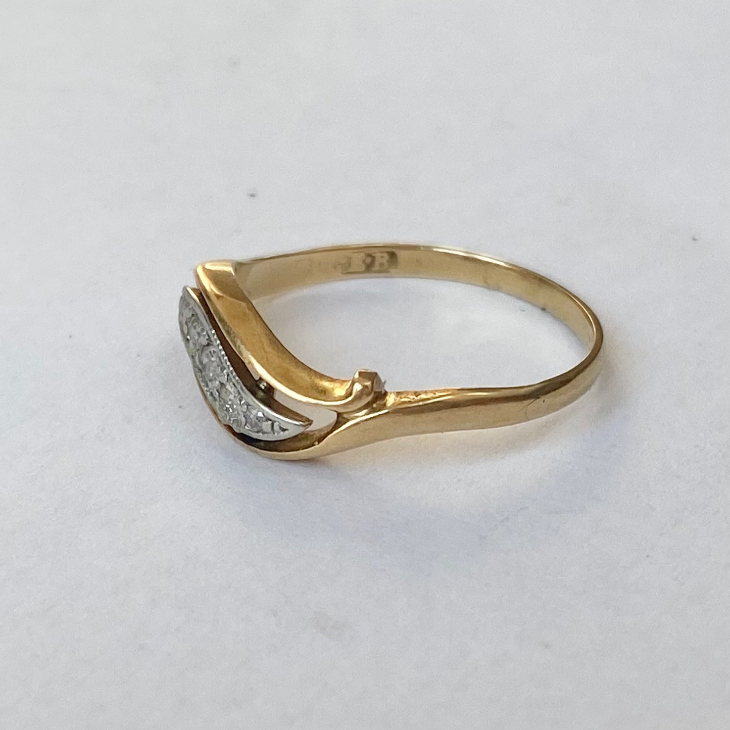 A mid 20th century gold old cut diamond undulating pinky ring.