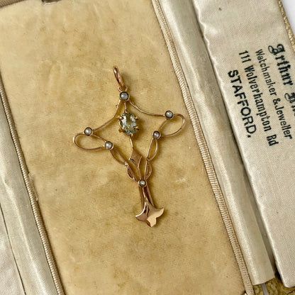 An Art Nouveau gold topaz and split pearl pendant.
