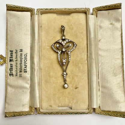 An Edwardian silver colourless paste foliate pendant.
