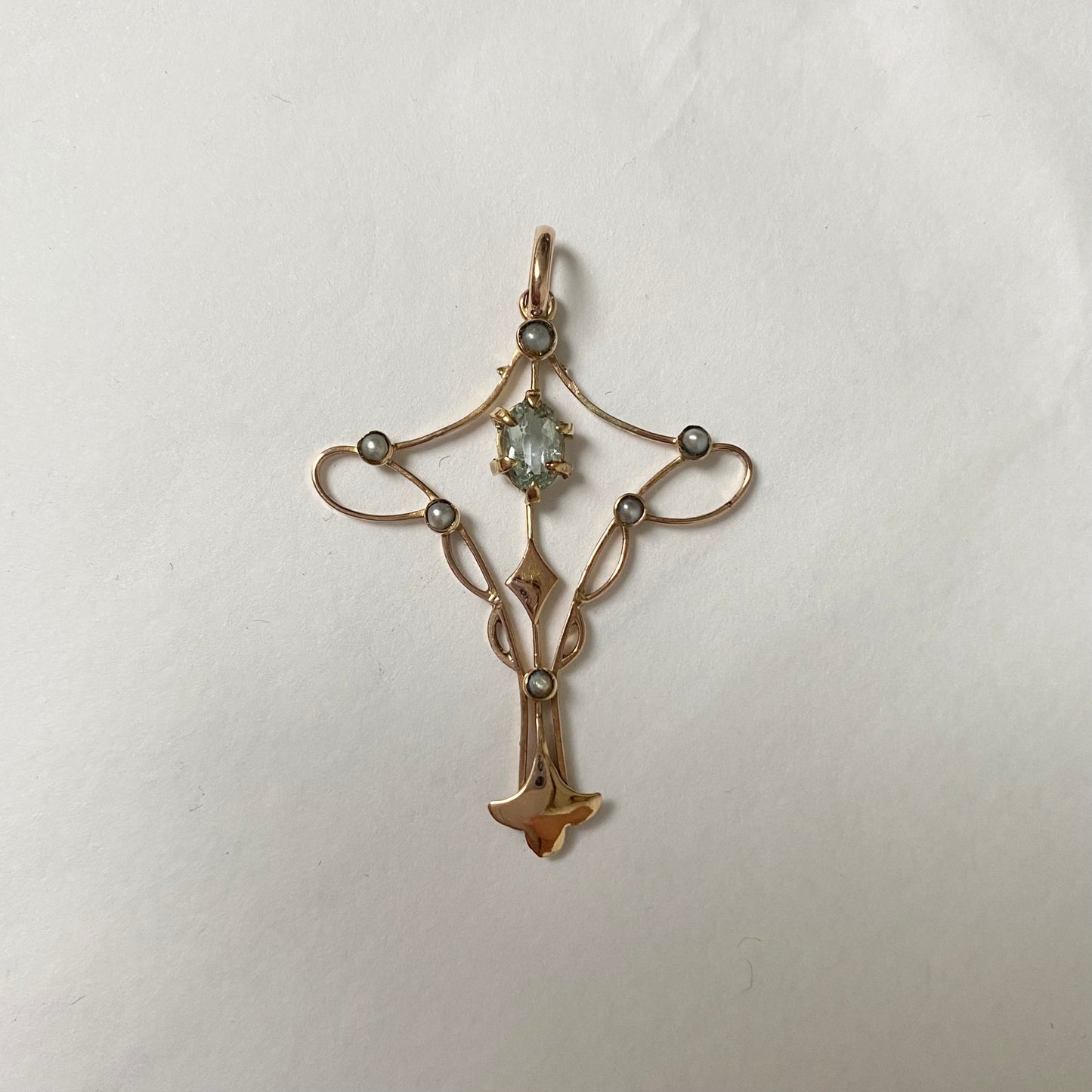 An Art Nouveau gold topaz and split pearl pendant.