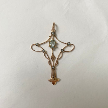An Art Nouveau gold topaz and split pearl pendant.