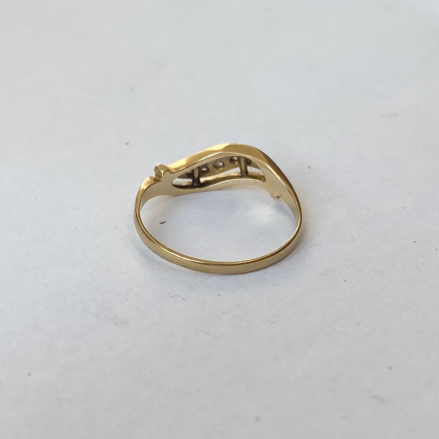 A mid 20th century gold old cut diamond undulating pinky ring.