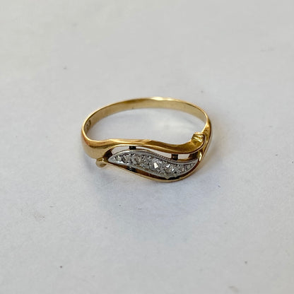 A mid 20th century gold old cut diamond undulating pinky ring.