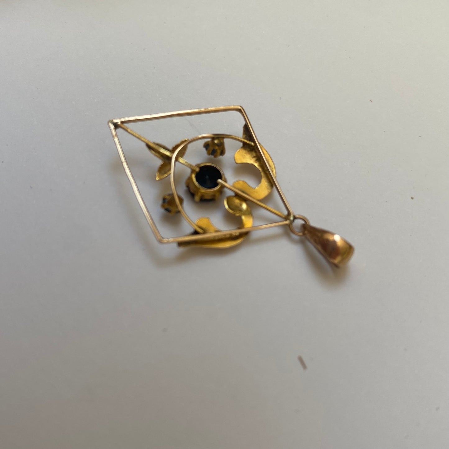 Early 20th century 9ct gold kite-shape pendant, set with sapphires.