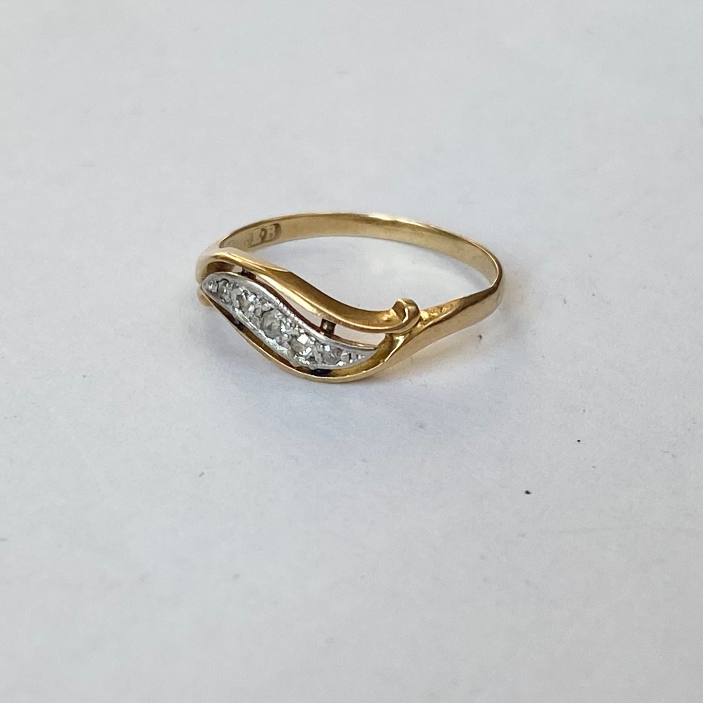 A mid 20th century gold old cut diamond undulating pinky ring.