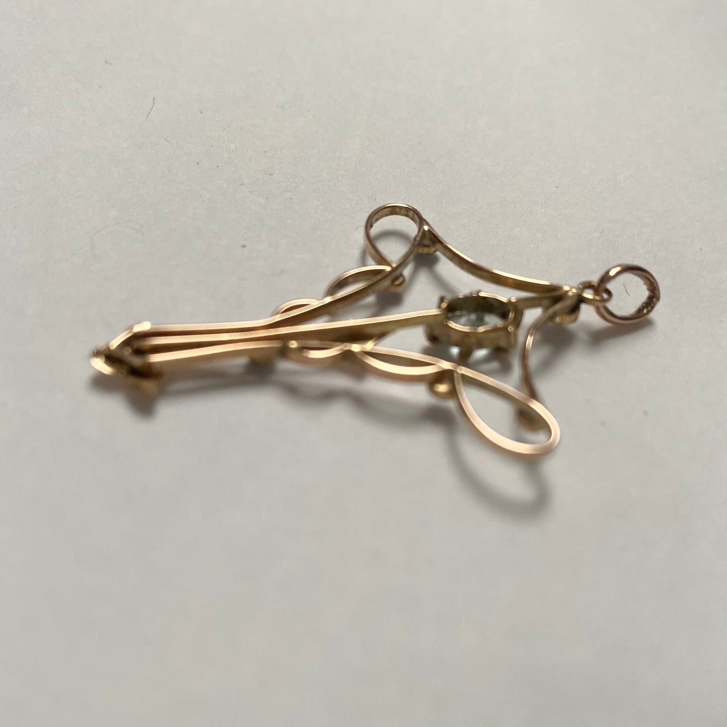An Art Nouveau gold topaz and split pearl pendant.